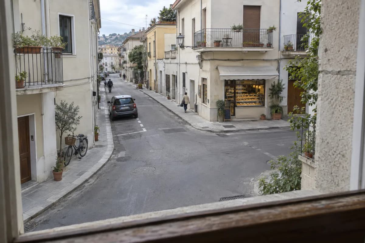 AI-created illustrative scene: A view from a guesthouse window onto an ordinary neighborhood street.